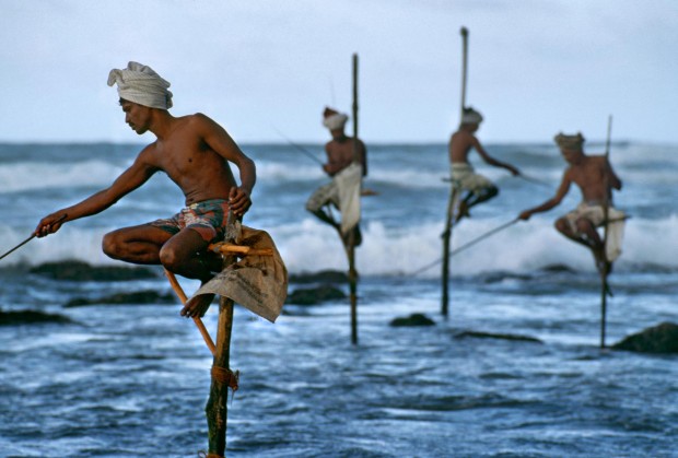 Weligama, South coast, Sri Lanka, 1995."Fishermen along the southern coast of Sri Lanka cast their lines in the traditional way atop poles so they can work in shallow water without disturbing the fish."  - George Eastman HouseThe theatrical stage would not offer a finer gesture, nor a more equisite doubling between the near and the far, than does this picture.  McCurry captures the beauty of a cultural tradition and with it a natural choreography.  This image also preserves a practice now essentially lost to technology, having all but disappeared in the intervening years since the photograph was made.  -Anthony Bannon Magnum Photos, NYC5948; MCS1995006K200, Phaidon, 55, South Southeast, Iconic Images, final book_iconic